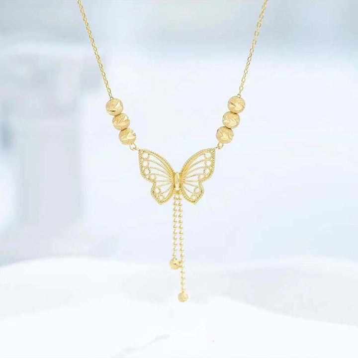 BowLift | Necklace with gold-colored butterfly with tassels